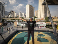 Sogand Salari, an Iranian diver, is performing while jumping during a street diving event organized and held by Tehran's Adrenaline Park, in...