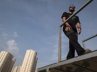 A young Iranian diver is preparing to jump during a street diving event organized and held by Tehran's Adrenaline Park, in a recreation area...