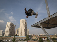 A young Iranian diver is jumping during a street diving event organized and held by Tehran's Adrenaline Park, in a recreation area in wester...