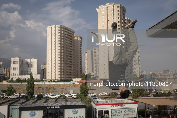 A young Iranian diver is jumping during a street diving event organized and held by Tehran's Adrenaline Park, in a recreation area in wester...