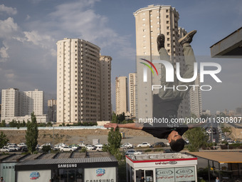 A young Iranian diver is jumping during a street diving event organized and held by Tehran's Adrenaline Park, in a recreation area in wester...