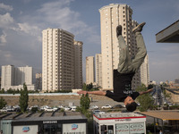 A young Iranian diver is jumping during a street diving event organized and held by Tehran's Adrenaline Park, in a recreation area in wester...