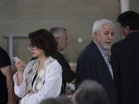 A young Iranian woman, who is not wearing a mandatory headscarf, is attending an electoral campaign rally for Masoud Pezeshkian, a reformist...