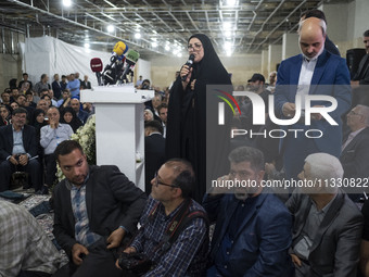 Farideh Oladghobad (C), a former reformist female member of parliament, is delivering speeches while participating in an electoral campaign...