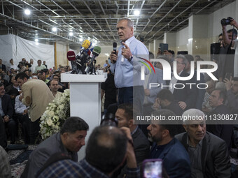 Masoud Pezeshkian, a reformist presidential candidate, is speaking to his supporters while attending an electoral campaign rally in northwes...