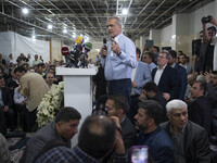 Masoud Pezeshkian, a reformist presidential candidate, is speaking to his supporters while attending an electoral campaign rally in northwes...