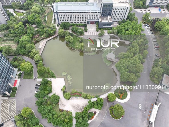 A lake shaped like a map of China is being seen at a university in Hangzhou, Zhejiang province, China, on June 14, 2024. 