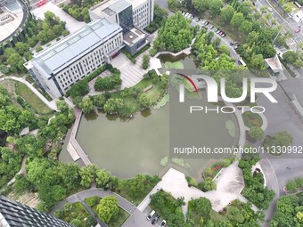 A lake shaped like a map of China is being seen at a university in Hangzhou, Zhejiang province, China, on June 14, 2024. (