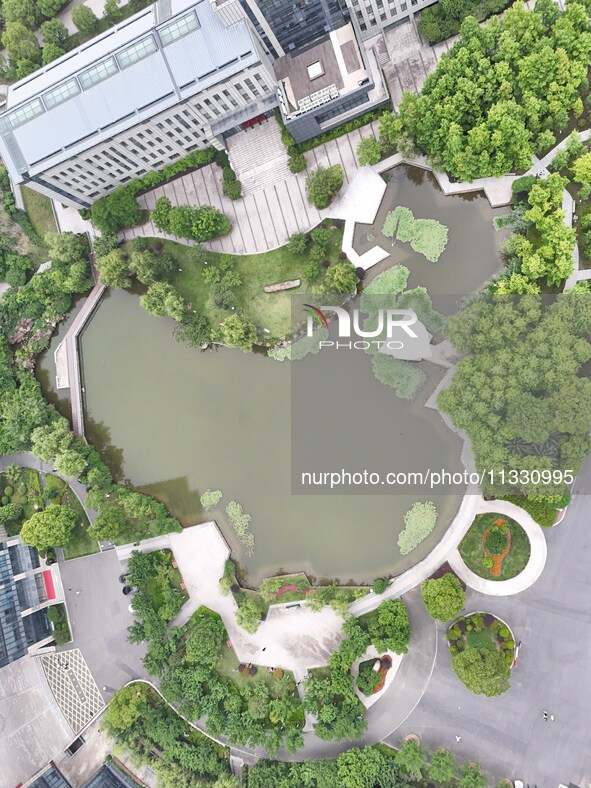 A lake shaped like a map of China is being seen at a university in Hangzhou, Zhejiang province, China, on June 14, 2024. 