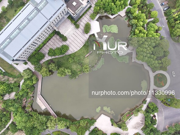 A lake shaped like a map of China is being seen at a university in Hangzhou, Zhejiang province, China, on June 14, 2024. 