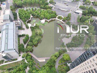 A lake shaped like a map of China is being seen at a university in Hangzhou, Zhejiang province, China, on June 14, 2024. (