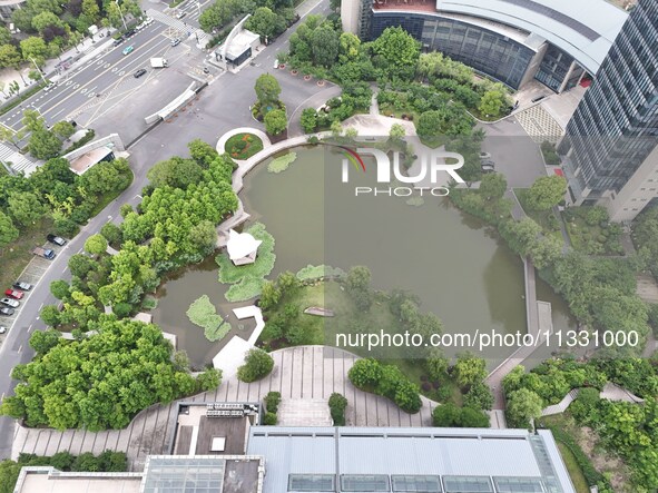 A lake shaped like a map of China is being seen at a university in Hangzhou, Zhejiang province, China, on June 14, 2024. 