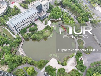 A lake shaped like a map of China is being seen at a university in Hangzhou, Zhejiang province, China, on June 14, 2024. (