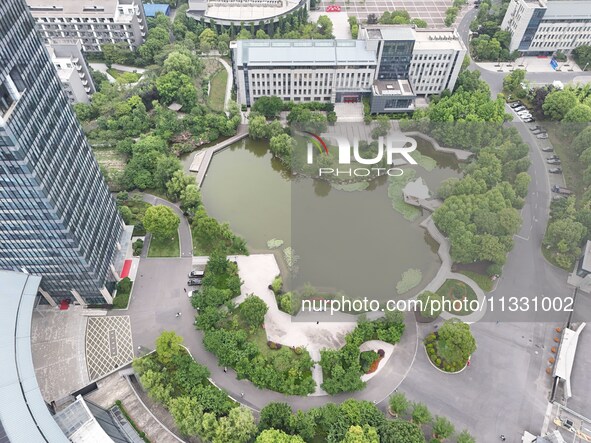 A lake shaped like a map of China is being seen at a university in Hangzhou, Zhejiang province, China, on June 14, 2024. 