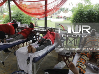 Volunteers are donating blood during the Lagos State Blood Transfusion Committee's awareness walk to mark 2024 World Blood Donor Day at JJT...