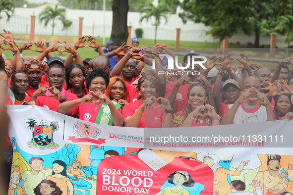 Members of the Lagos State Blood Transfusion Committee and other participants are showing signs of love during the committee's awareness wal...