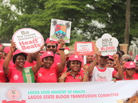 Members of the Lagos State Blood Transfusion Committee and others are participating in the committee's awareness walk to mark 2024 World Blo...