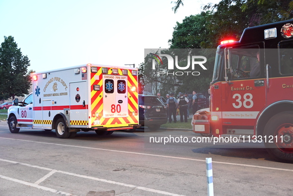 An ambulance and a fire engine are arriving first at the crime scene where a 13-year-old is being shot and critically wounded in Chicago, Il...