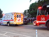 An ambulance and a fire engine are arriving first at the crime scene where a 13-year-old is being shot and critically wounded in Chicago, Il...