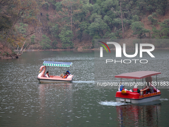 People are boating along Sattal Lake in Sattal (Sat Tal), Uttarakhand, India, on April 20, 2024. (