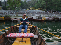 A boatman is rowing a boat along Sattal Lake in Sattal (Sat Tal), Uttarakhand, India, on April 20, 2024. (