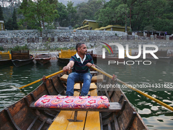 A boatman is rowing a boat along Sattal Lake in Sattal (Sat Tal), Uttarakhand, India, on April 20, 2024. (