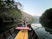 A boatman is rowing a boat along Sattal Lake in Sattal (Sat Tal), Uttarakhand, India, on April 20, 2024. (