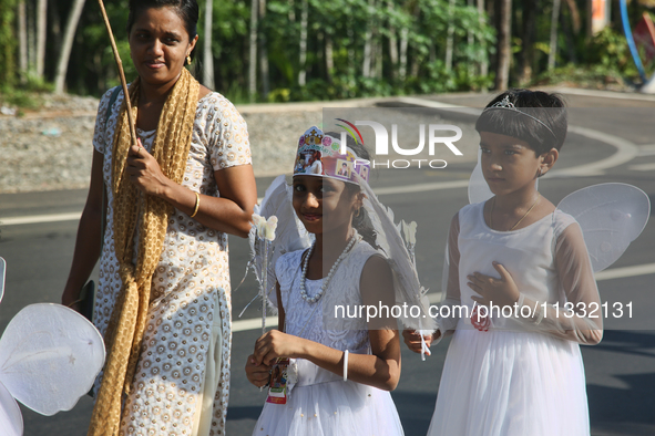 Youth dressed as angels from Saint George Orthodox Church are taking part in a procession in Kalathoor, Kerala, India, on April 05, 2024. 