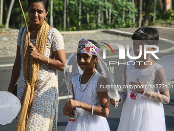 Youth dressed as angels from Saint George Orthodox Church are taking part in a procession in Kalathoor, Kerala, India, on April 05, 2024. (