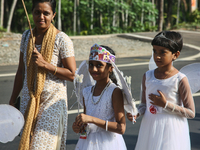 Youth dressed as angels from Saint George Orthodox Church are taking part in a procession in Kalathoor, Kerala, India, on April 05, 2024. (