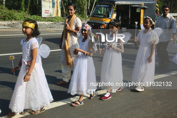 Youth dressed as angels from Saint George Orthodox Church are taking part in a procession in Kalathoor, Kerala, India, on April 05, 2024. 