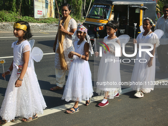 Youth dressed as angels from Saint George Orthodox Church are taking part in a procession in Kalathoor, Kerala, India, on April 05, 2024. (