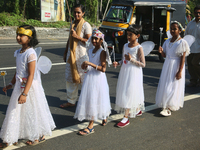 Youth dressed as angels from Saint George Orthodox Church are taking part in a procession in Kalathoor, Kerala, India, on April 05, 2024. (