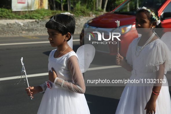 Youth dressed as angels from Saint George Orthodox Church are taking part in a procession in Kalathoor, Kerala, India, on April 05, 2024. 