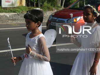 Youth dressed as angels from Saint George Orthodox Church are taking part in a procession in Kalathoor, Kerala, India, on April 05, 2024. (