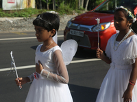 Youth dressed as angels from Saint George Orthodox Church are taking part in a procession in Kalathoor, Kerala, India, on April 05, 2024. (