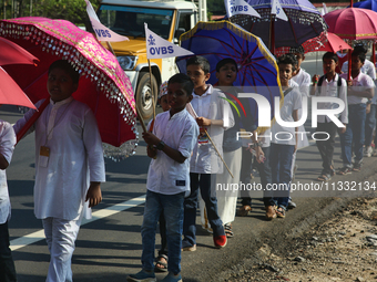 Youth from Saint George Orthodox Church are taking part in a procession in Kalathoor, Kerala, India, on April 05, 2024. (