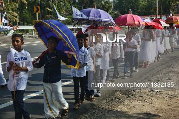 Youth from Saint George Orthodox Church are taking part in a procession in Kalathoor, Kerala, India, on April 05, 2024. 