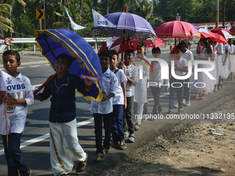 Youth from Saint George Orthodox Church are taking part in a procession in Kalathoor, Kerala, India, on April 05, 2024. (