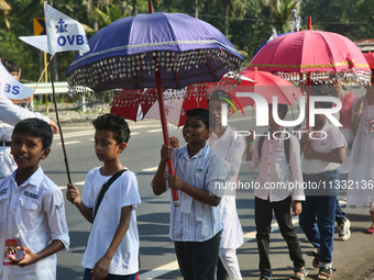 Youth from Saint George Orthodox Church are taking part in a procession in Kalathoor, Kerala, India, on April 05, 2024. (