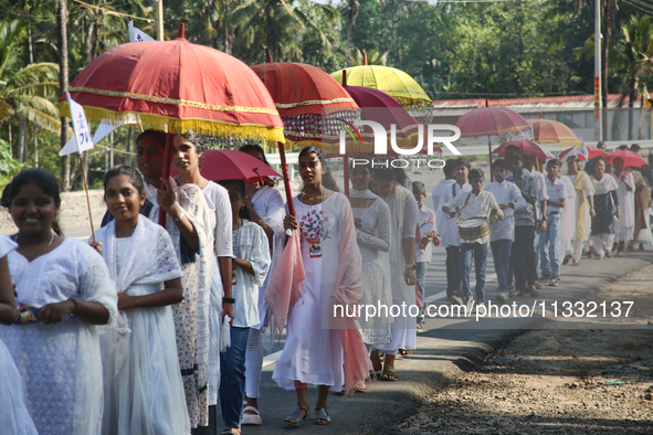 Youth from Saint George Orthodox Church are taking part in a procession in Kalathoor, Kerala, India, on April 05, 2024. 