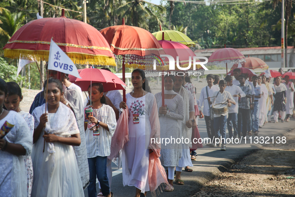 Youth from Saint George Orthodox Church are taking part in a procession in Kalathoor, Kerala, India, on April 05, 2024. 