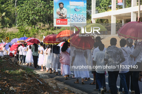 Youth from Saint George Orthodox Church are taking part in a procession in Kalathoor, Kerala, India, on April 05, 2024. 