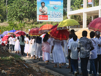 Youth from Saint George Orthodox Church are taking part in a procession in Kalathoor, Kerala, India, on April 05, 2024. (