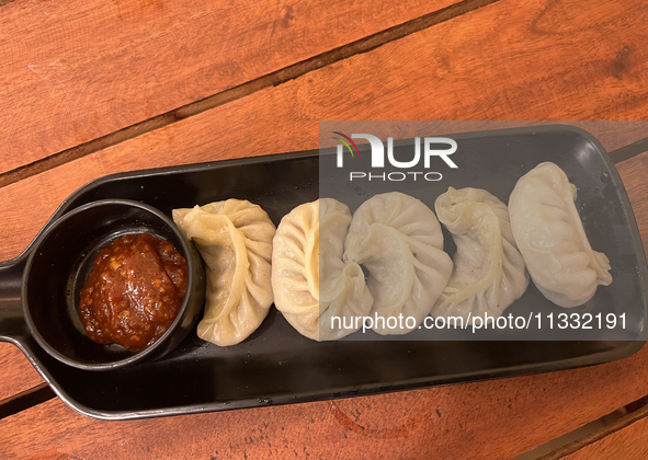 Momos are being served with a side of chili sauce at a cafe in Thiruvananthapuram (Trivandrum), Kerala, India, on April 10, 2024. 