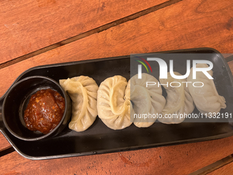 Momos are being served with a side of chili sauce at a cafe in Thiruvananthapuram (Trivandrum), Kerala, India, on April 10, 2024. (