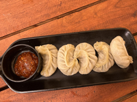 Momos are being served with a side of chili sauce at a cafe in Thiruvananthapuram (Trivandrum), Kerala, India, on April 10, 2024. (