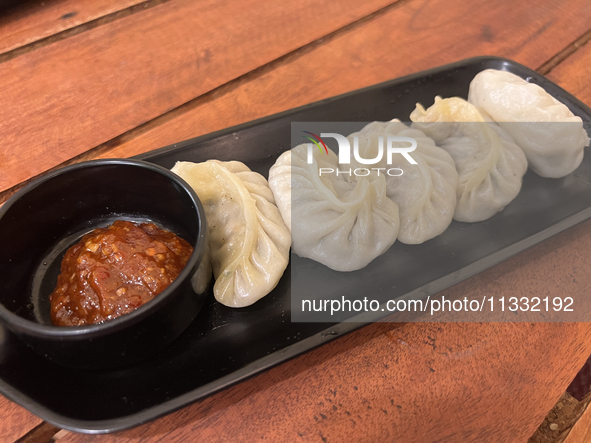 Momos are being served with a side of chili sauce at a cafe in Thiruvananthapuram (Trivandrum), Kerala, India, on April 10, 2024. 