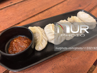 Momos are being served with a side of chili sauce at a cafe in Thiruvananthapuram (Trivandrum), Kerala, India, on April 10, 2024. (