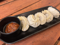 Momos are being served with a side of chili sauce at a cafe in Thiruvananthapuram (Trivandrum), Kerala, India, on April 10, 2024. (